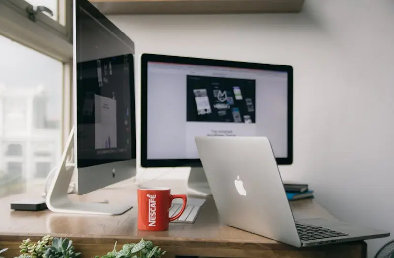 Silver MacBook on a wooden table